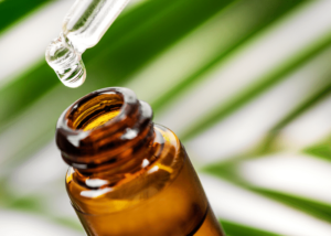 A drop of cbd oil when extracting in a bottle.